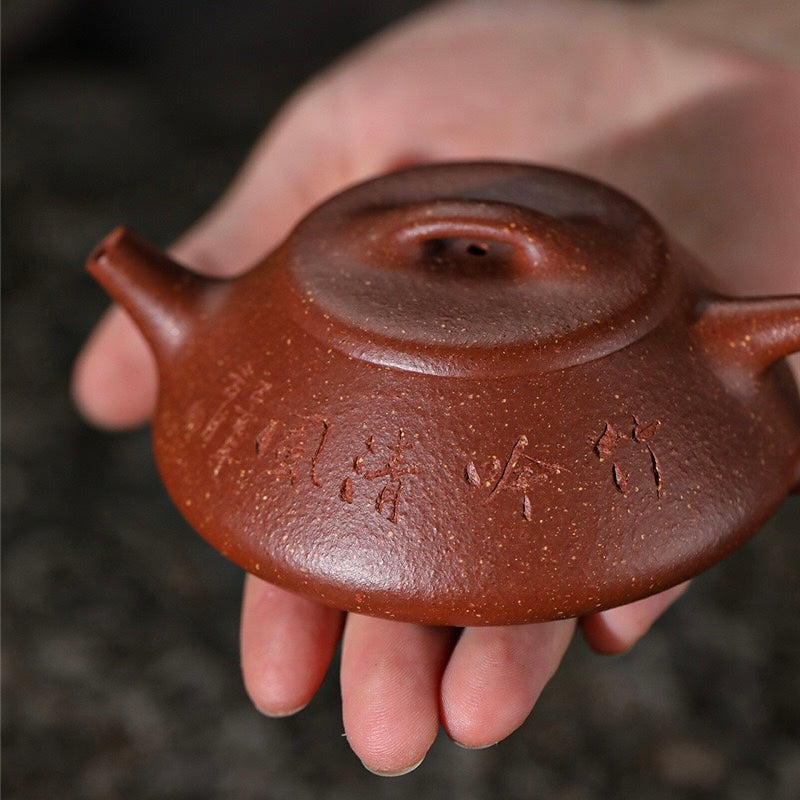 Front handheld view showing hand carved calligraphy art on Master Ding Hongbin Yixing Shipiao Zisha teapot, aged rare warm jade clay heirloom tea ware SONGKILN