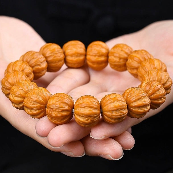 Hand spread shot of matched size natural wenwan walnut worry beads, unique natural grain wearable collectible bracelet SONGKILN