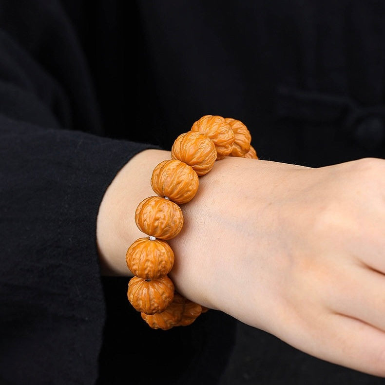 Lifestyle wrist wearing photo of SONGKILN 11mm walnut worry bead bracelet, suitable for yoga travel daily stress relief meditation ornament